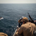 Sailors assigned to the USS Carney respond to a small-craft vessel during an antiterrorism drill in the area of operations of the U.S. Navy’s 5th Fleet, Dec. 6, 2023. / Photo By: Navy Petty Officer 2nd Class Aaron Lau / defense.gov